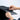 Hands adjusting the zipper of the Sleepypod® Air premium pet travel carrier for added convenience and comfort.