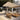 Umbrosa Versa PX cuadrado sobre un rincón lounge con pérgola de madera y olivos