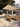 Umbrosa Versa PX cuadrado sobre un rincón lounge con pérgola de madera y olivos