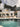 Umbrosa Versa PX cantilever parasol with mobile base by the pool of a white villa